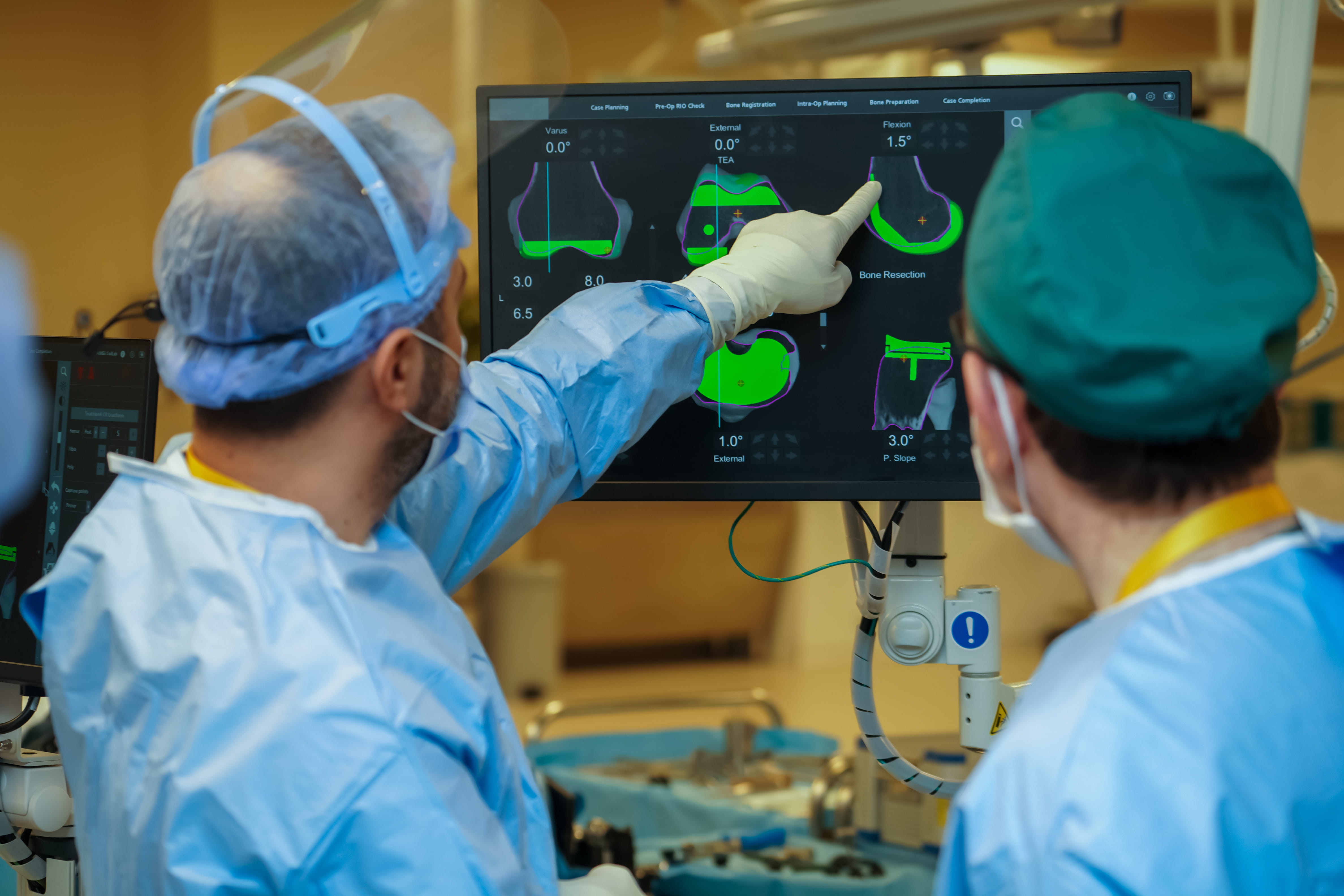 Surgeon pointing to data on a medical screen