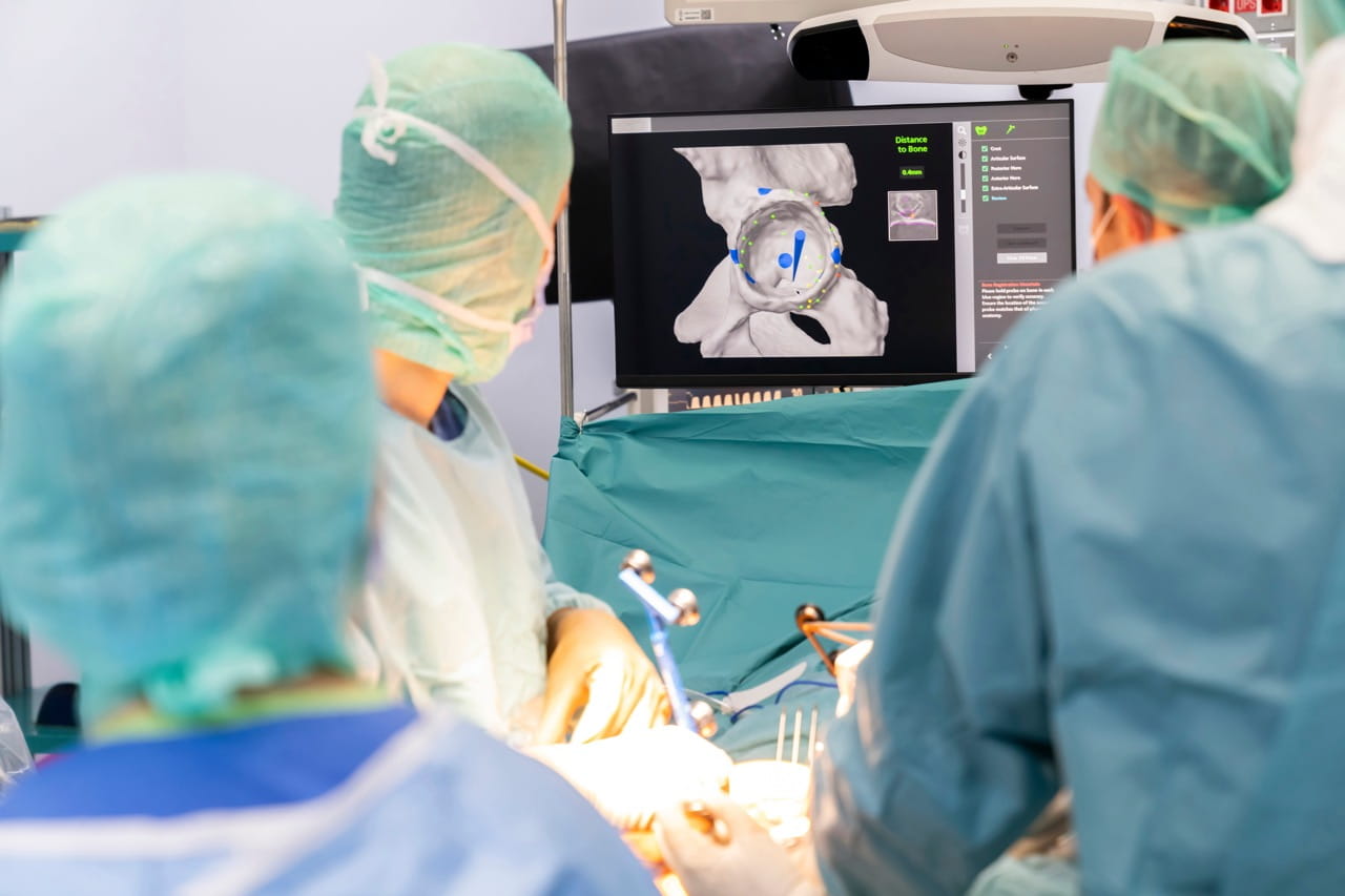 Surgeons using robotic technology during an operation